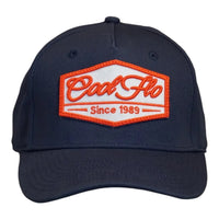 Front view of a Cool Flo Since 1989 baseball cap in Navy featuring an embroidered Since 1989 badge in Orange and White and a curved visor
