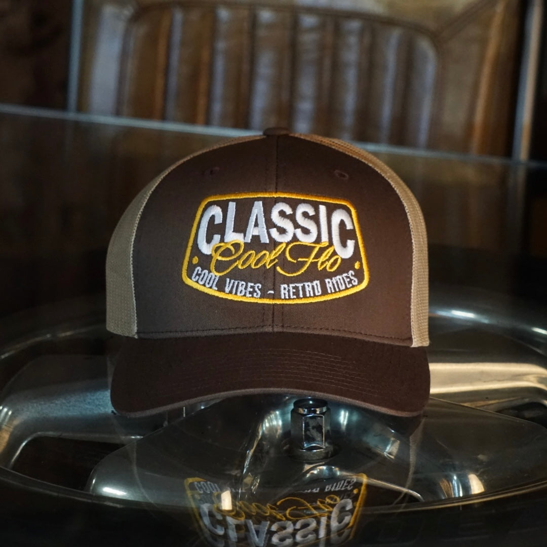 Cool Flo brown and khaki trucker cap with embroidered yellow and white 'Classic, cool vibes, retro rides' design.