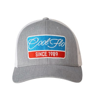 Cool Flo Grey and white Retro Badge trucker cap with embroidered blue, red and white Since '89 badge design