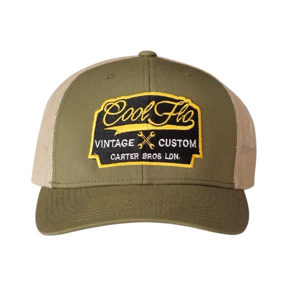 Cool Flo Vintage Custom. Green and khaki trucker cap with embroidered yellow, black and white badge with cross-spanners. Carter Bros. London.