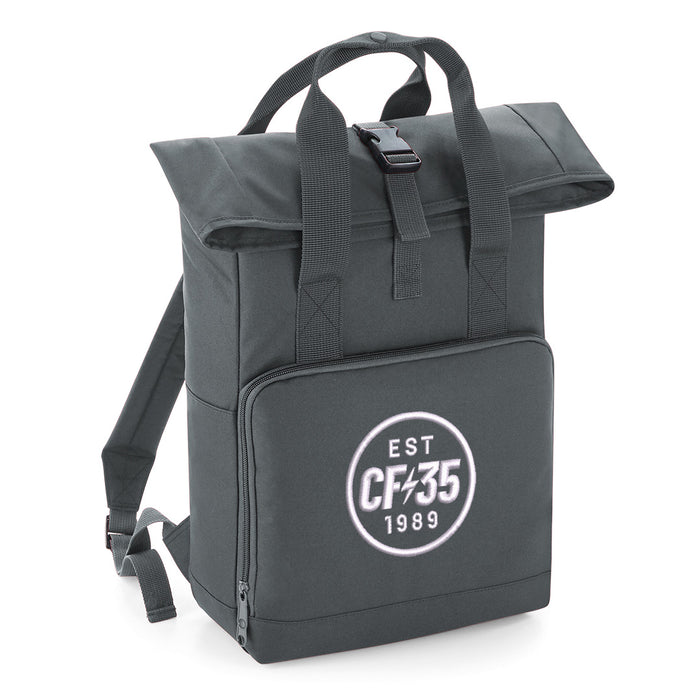 Grey rolltop backpack with embroidered white CF35 anniversary logo on front pocket