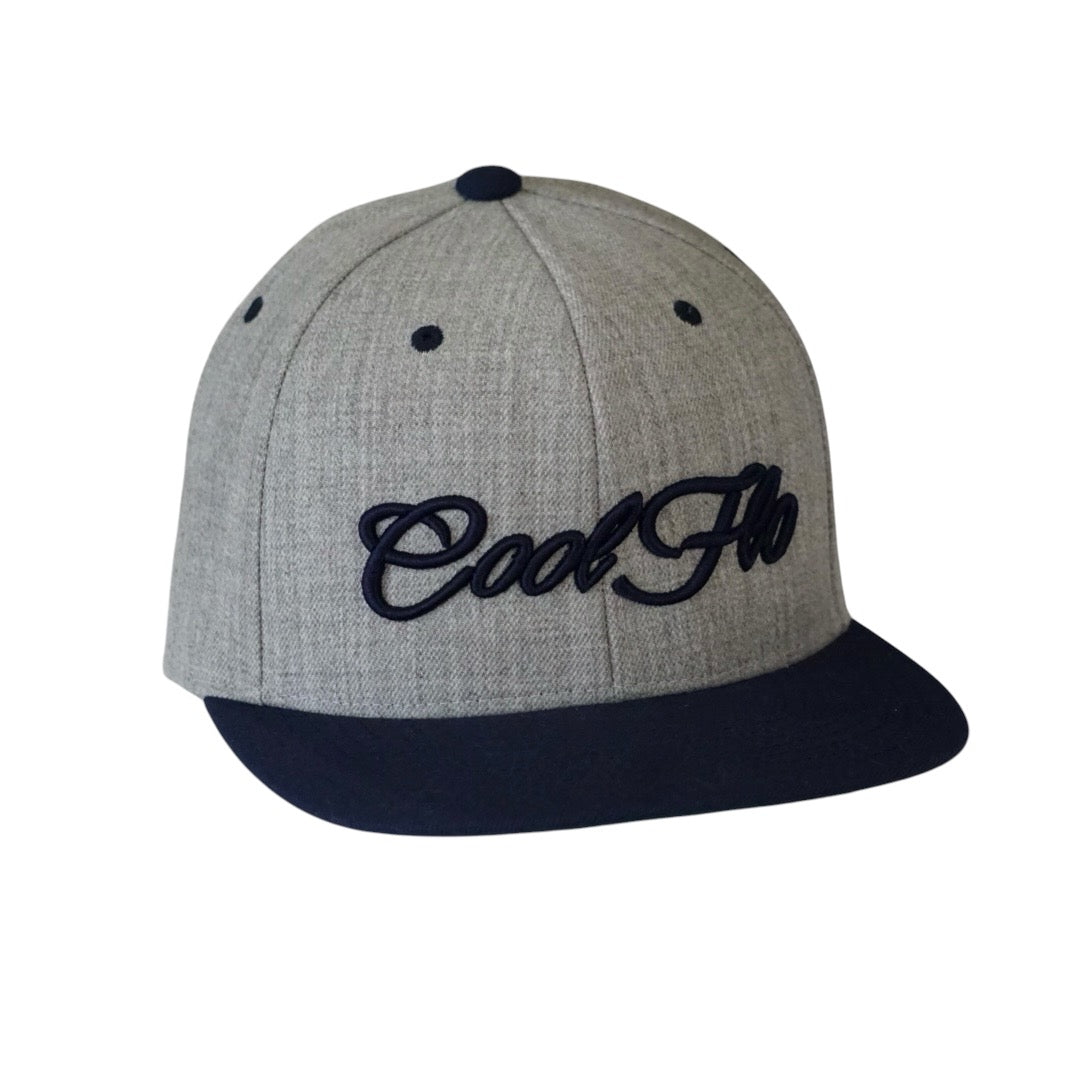 Two tone heather and navy snapback cap with embroidered 3D script logo in navy on the front. 