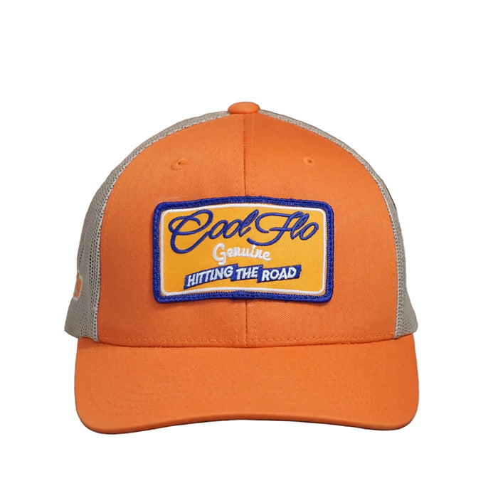 Front view of a Cool Flo Hitting The Road trucker cap in Orange/Khaki featuring an embroidered Hitting The Road badge in Orange, Blue and White and a curved visor