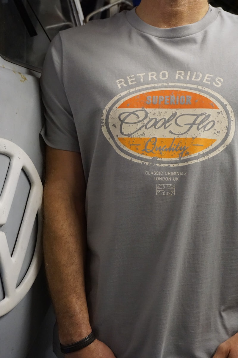 Model wearing a grey Cool Flo t-shirt with a retro-style 'Retro Rides' graphic, standing next to a vintage grey Volkswagen barndoor bus.