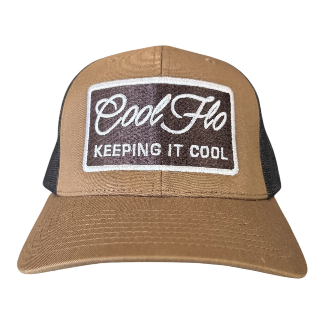 Front view of brown and black Keeping it Cool Two-tone Trucker Cap. Cool Flo logo and 'Keeping it Cool' rectangular badge design embroidered on the front in brown and white.