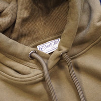 Close-up of neck and hood-pulls on khaki hoody with large embroidered 25cm logo in cream.