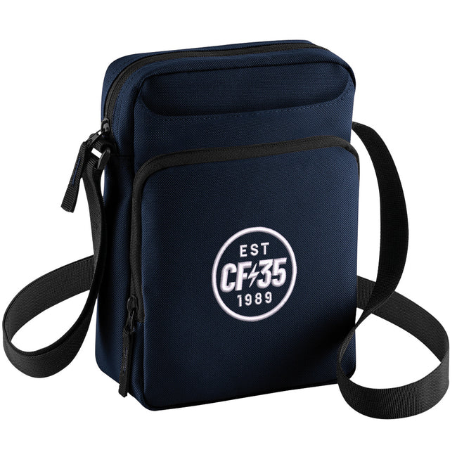 CF35 navy cross-body bag with embroidered white CF35 anniversary logo on front pocket