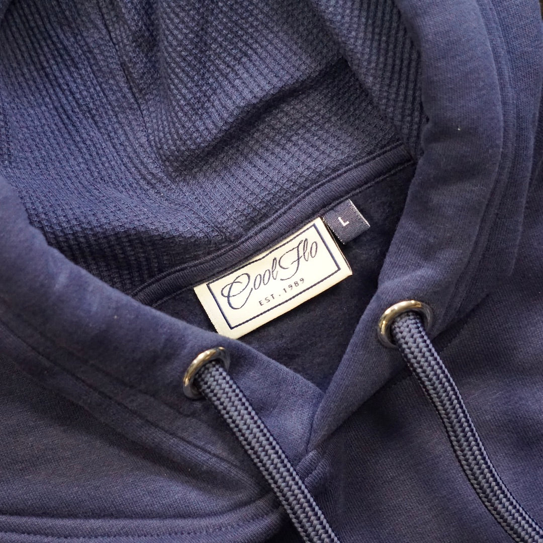 Close-up of neck detail on Navy blue hoody with large Cool Flo script logo in matching high-build 3D embroidery .