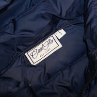 Close-up of neck label on Navy blue gilet with matching Cool Flo script logo embroidered on the left.
