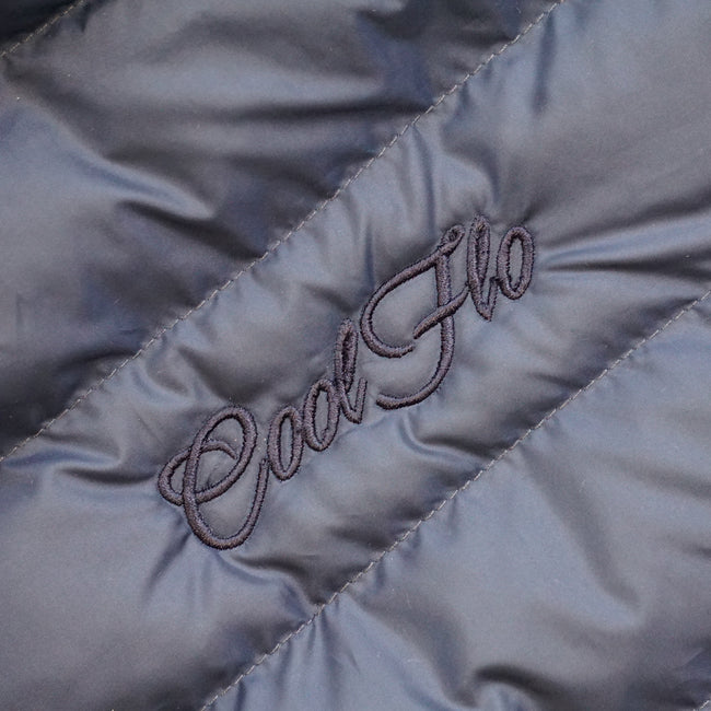 Close-up of embroidery on Navy blue gilet with matching Cool Flo script logo embroidered on the left.