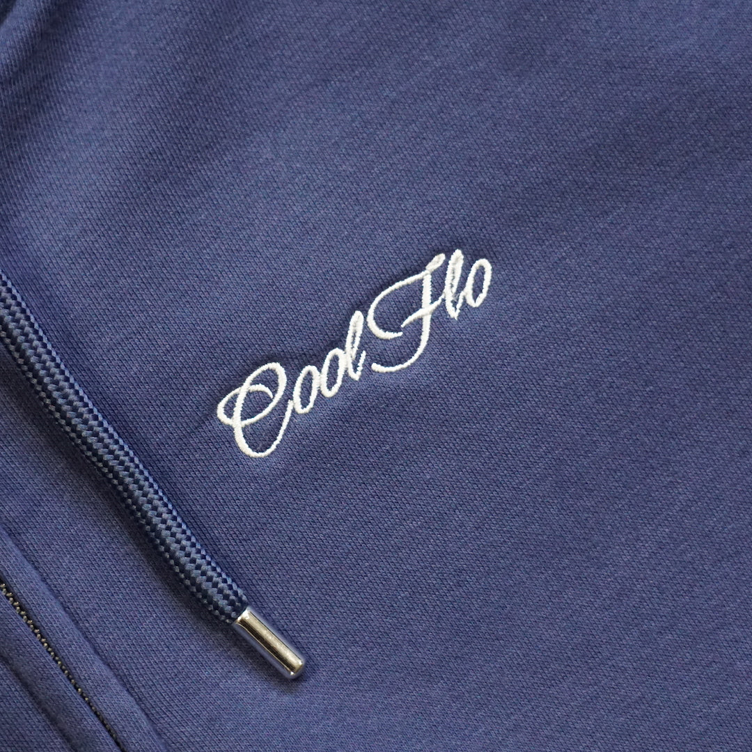 Close-up of embroidery on navy zip-hoody with light grey embroidered Cool Flo script logo on left chest.