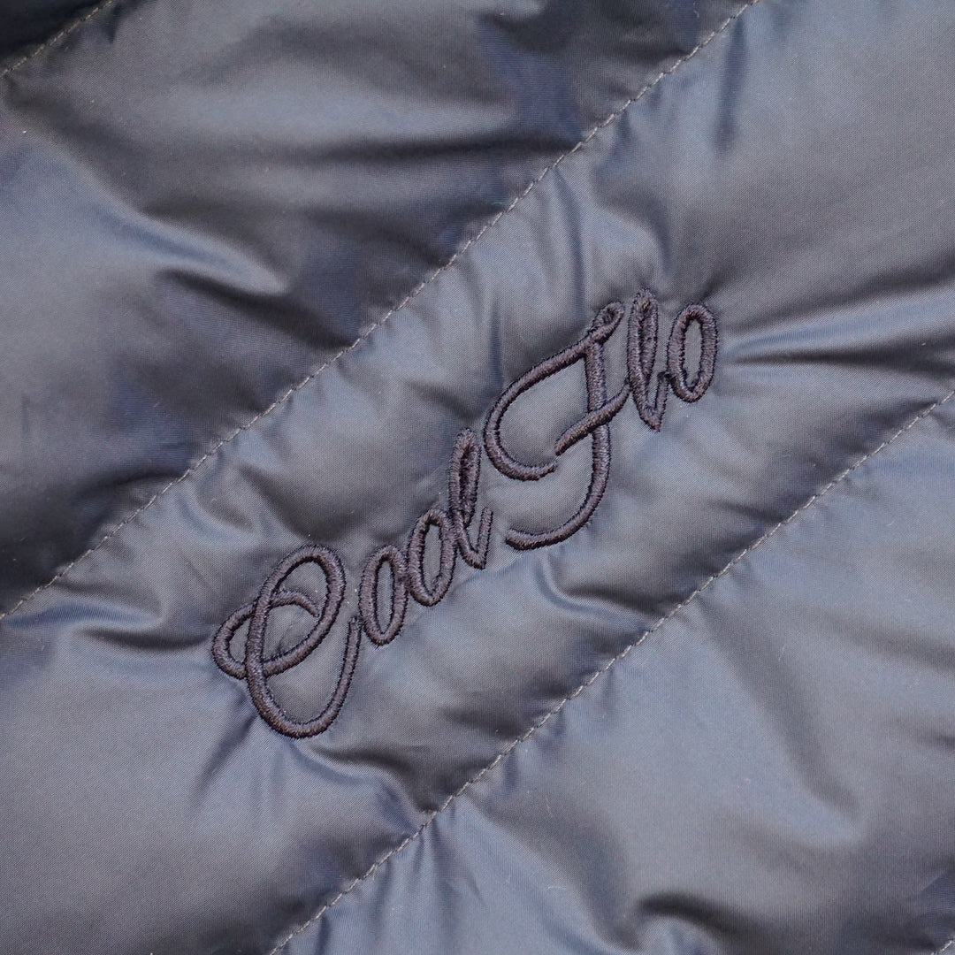 Close-up of embroidery on premium navy puffer jacket with matching Cool Flo script logo embroidered on the left.