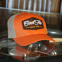 Cool Flo orange and khaki trucker cap with brown, white and orange 3D puff embroidered badge sewn onto the front.