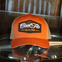 Cool Flo orange and khaki trucker cap with brown, white and orange 3D puff embroidered badge sewn onto the front.