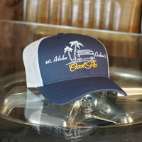 Aloha Outlaw two-tone navy and silver/grey trucker cap with embroidered VW bus and palm tree design.