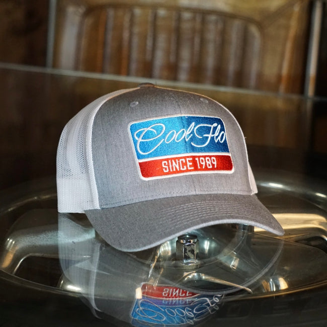 Cool Flo Grey and white Retro Badge trucker cap with embroidered blue, red and white Since '89 badge design