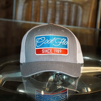 Cool Flo Grey and white Retro Badge trucker cap with embroidered blue, red and white Since '89 badge design