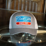Cool Flo Grey and white Retro Badge trucker cap with embroidered blue, red and white Since '89 badge design