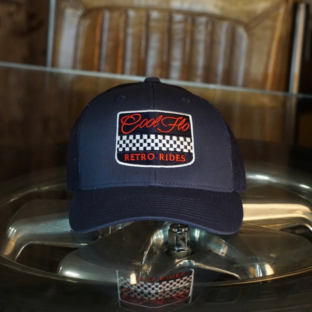 Cool Flo Retro Rides Navy trucker cap with embroidered chequered badge design in white, red and navy.
