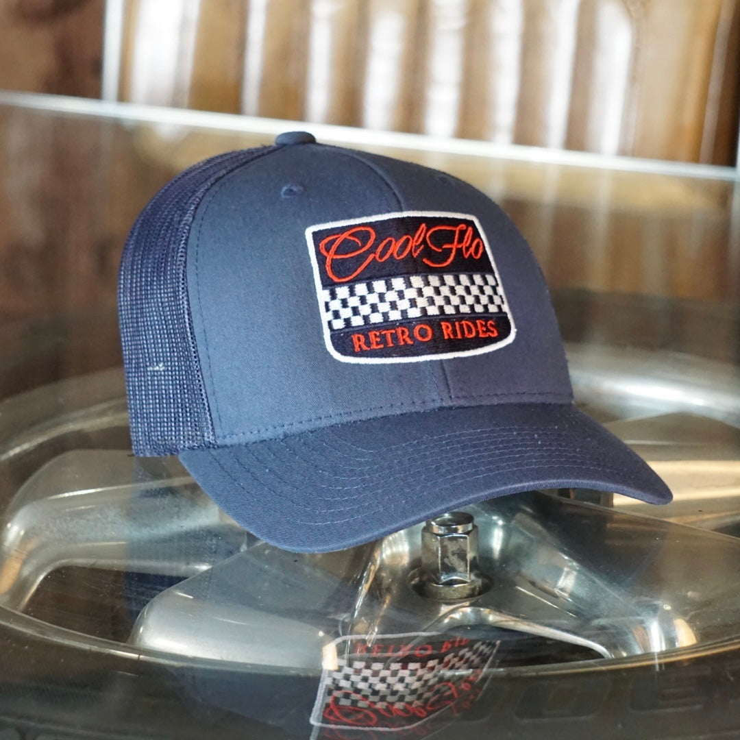 Cool Flo Retro Rides Navy trucker cap with embroidered chequered badge design in white, red and navy.