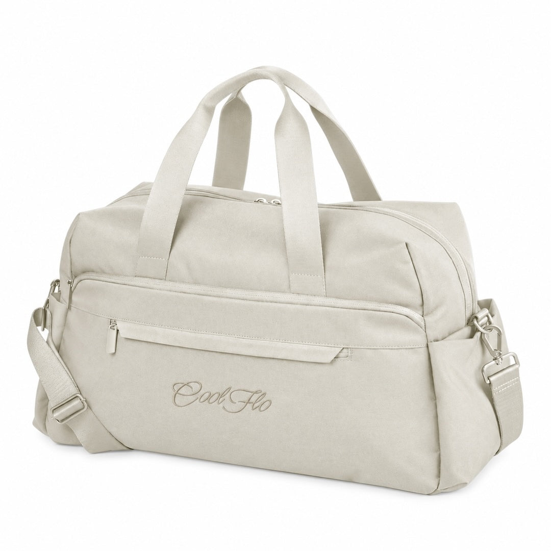 A stone-colour weekender bag with dual top handles, a front zippered pocket, and a detachable shoulder strap, featuring the script brand name 'Cool Flo' embroidered on the front, set against a plain white background.