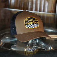 Cool Flo Black & brown trucker cap with  logo and Speed Shop chequered design in yellow, black and white embroidery.