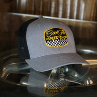 Cool Flo grey and black trucker cap with  logo and Speed Shop chequered design in yellow, black and white embroidery.