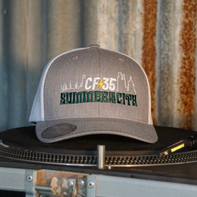 Centreforce Summer in the City event trucker cap (heather grey & white) placed on a record turntable 