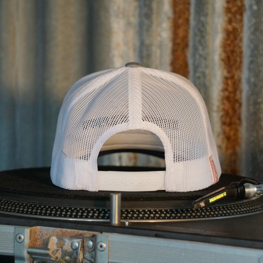 Centreforce Summer in the City event trucker cap (heather grey & white) placed on a record turntable 