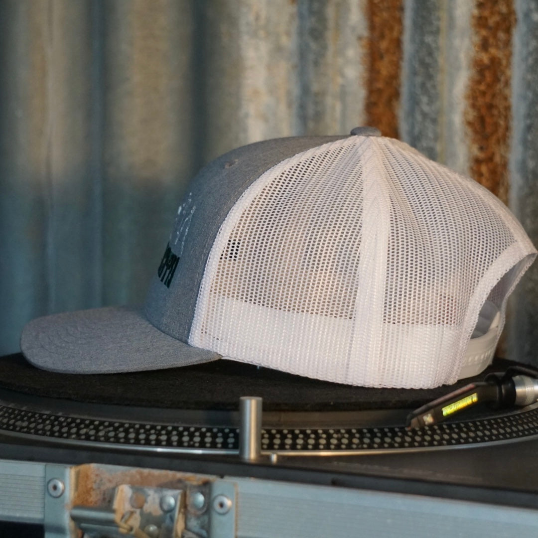 Centreforce Summer in the City event trucker cap (heather grey & white) placed on a record turntable 