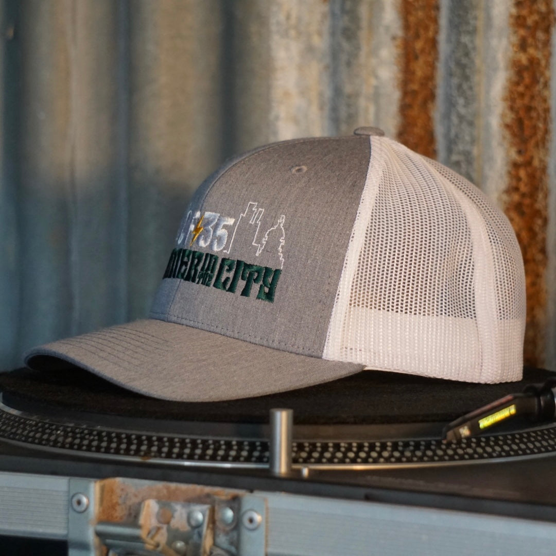 Centreforce Summer in the City event trucker cap (heather grey & white) placed on a record turntable 