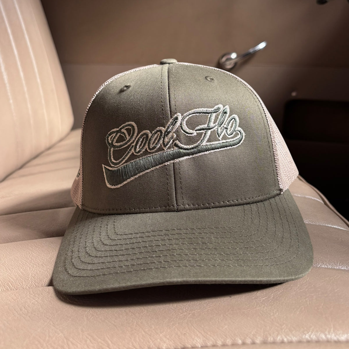 Front view of a Cool Flo Moss/Khaki trucker cap featuring a raised 3D embroidered Swoosh logo in Moss/Khaki and a curved visor