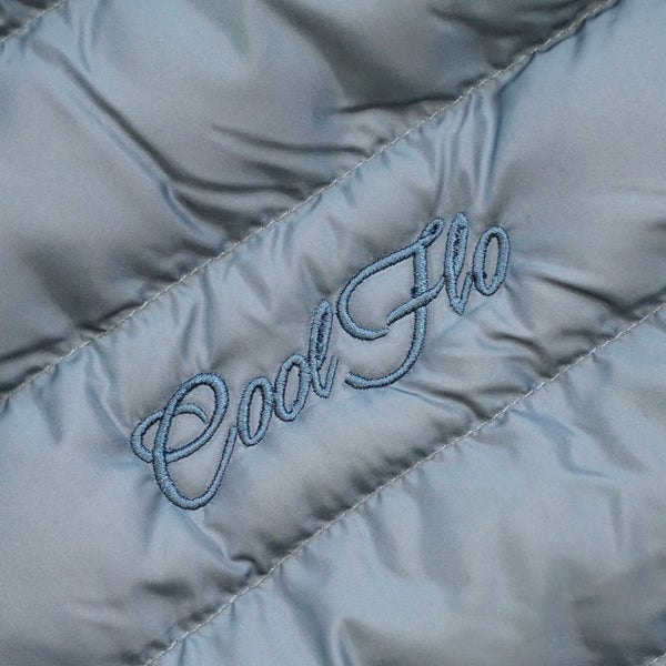 Close-up of embroidery on Teal premium puffer jacket with matching Cool Flo script logo embroidered on the left.