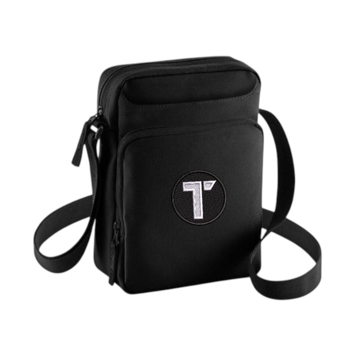 Tenacious black cross-body bag with an embroidered black and white 'T' logo on the front.