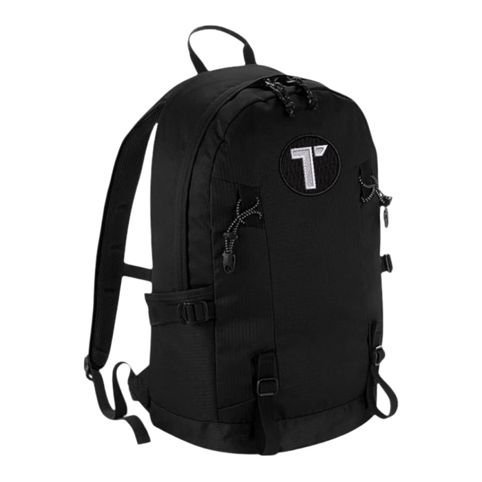 Tenacious black backpack with an embroidered black and white 'T' logo on the front.