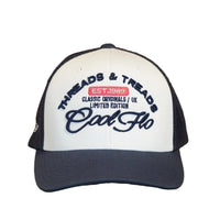 Front view of a Cool Flo Threads & Treads trucker cap in White/Navy featuring embroidered Threads & Treads artwork and a curved visor