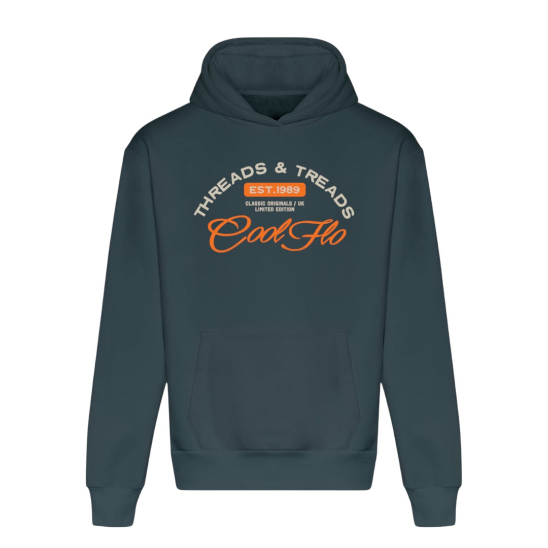 A teal hoody with a Cool Flo Threads and Treads print in cream and orange.