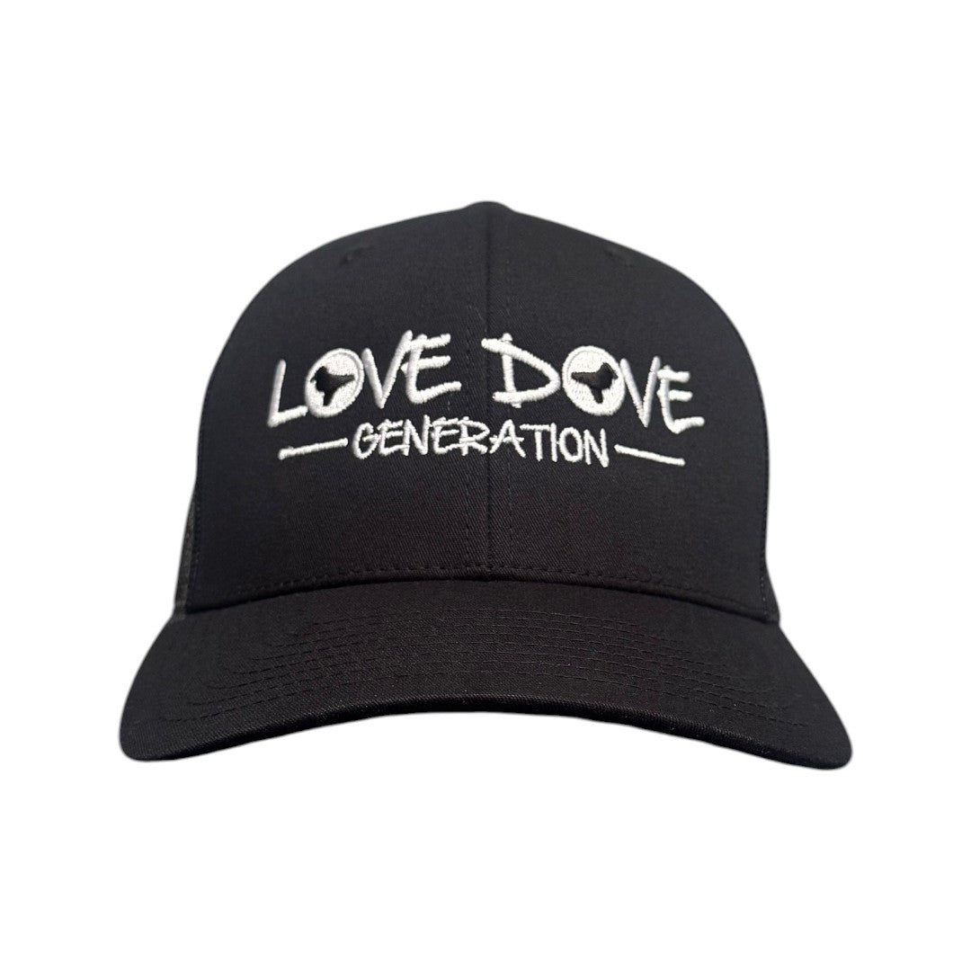 Black trucker cap with embroidered white 'Love Dove Generation' on the front_close up of embroidered logo - front view.