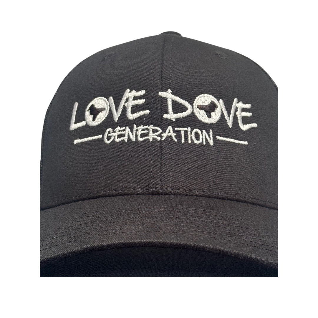 Black trucker cap with embroidered white 'Love Dove Generation' on the front_close up of embroidered logo -  close up of logo