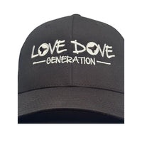 Black trucker cap with embroidered white 'Love Dove Generation' on the front_close up of embroidered logo -  close up of logo