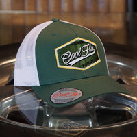 Cool Flo Vintage Classic Trucker Cap in fir green and white with an embroidered badge design with a retro feel. London - Cool Flo - Vintage Classic.