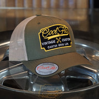Cool Flo Vintage Custom. Green and khaki trucker cap with embroidered yellow, black and white badge with cross-spanners. Carter Bros. London.