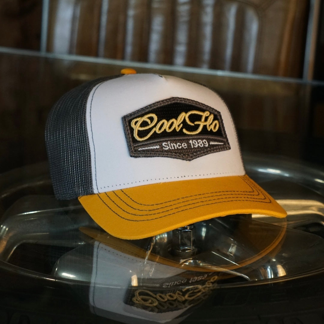 Yellow, white and grey trucker with 3D Cool Flo badge sewn on the front.