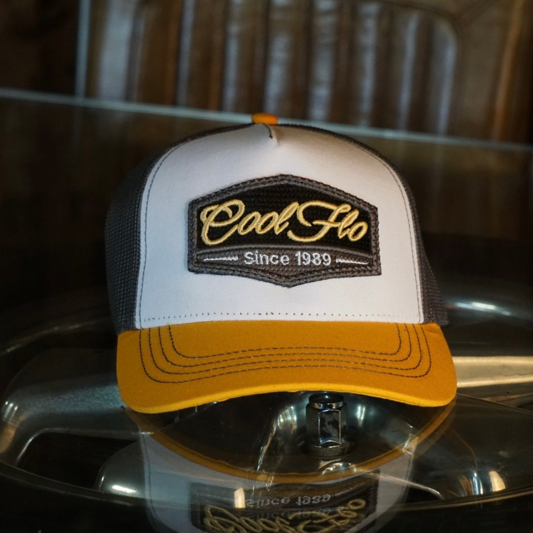 Yellow, white and grey trucker with 3D Cool Flo badge sewn on the front.