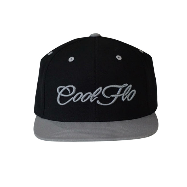 Two tone black and silver snapback cap with embroidered 3D script logo in silver on the front. 